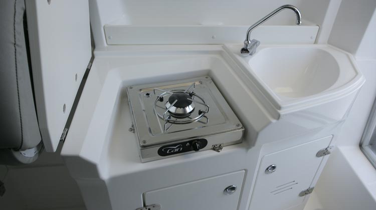 Gas stove under helm seat